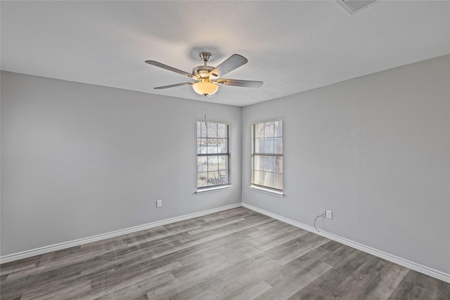 spare room featuring ceiling fan and light hardwood / wood-style floors