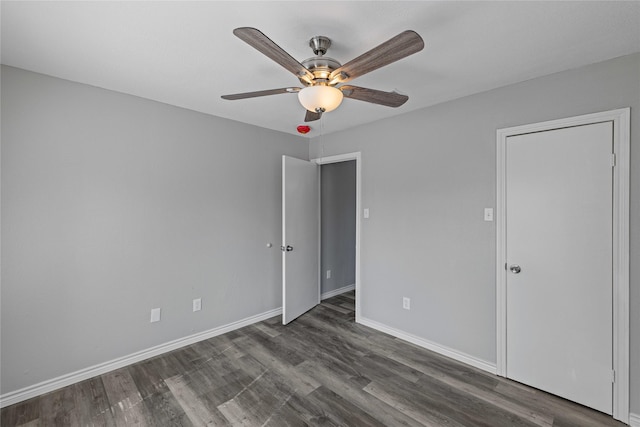 unfurnished bedroom featuring dark wood-type flooring and ceiling fan