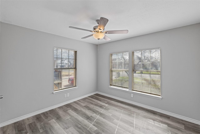 spare room featuring light wood-type flooring and ceiling fan