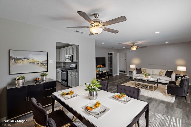 dining area featuring dark wood-type flooring and ceiling fan