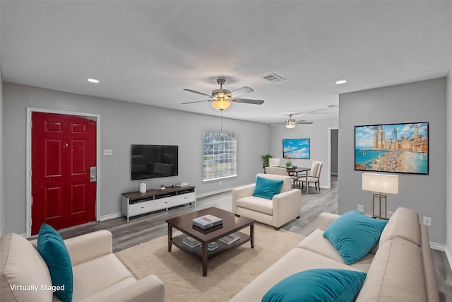 living room featuring wood-type flooring and a textured ceiling