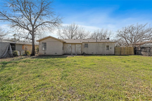 rear view of house featuring a yard