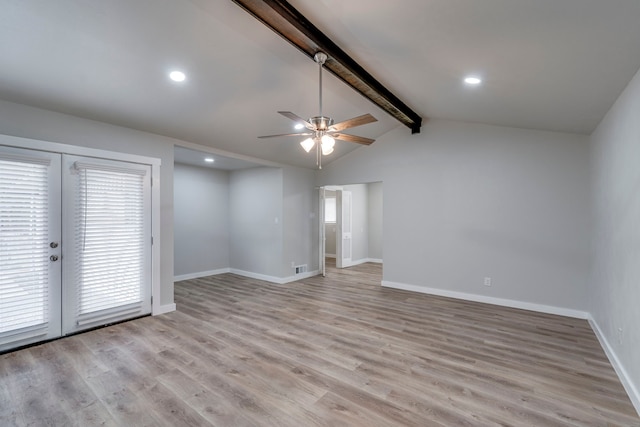 spare room with lofted ceiling with beams, ceiling fan, and light wood-type flooring