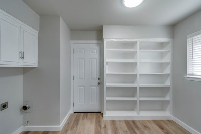 laundry area featuring electric dryer hookup and light hardwood / wood-style floors