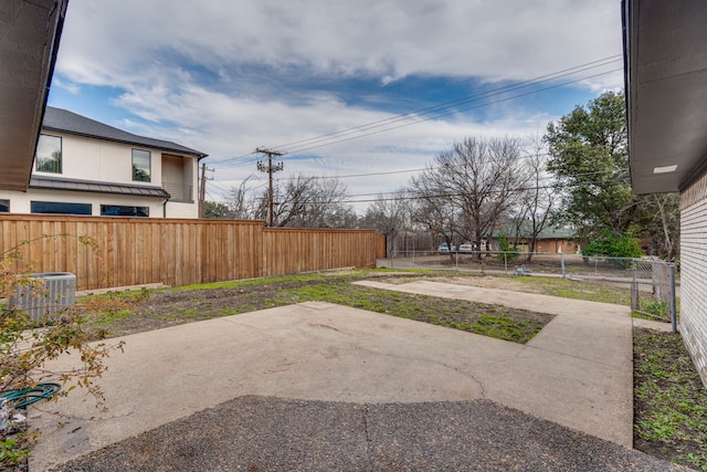 view of yard with a patio area and central air condition unit