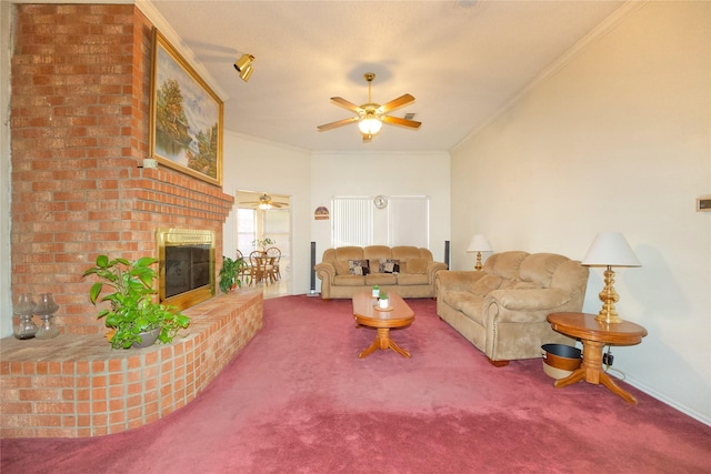 living room featuring crown molding, carpet floors, ceiling fan, and a fireplace