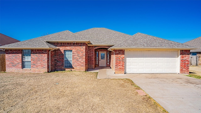 ranch-style house with a garage and a front yard