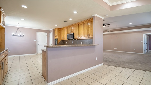 kitchen featuring crown molding, kitchen peninsula, ceiling fan with notable chandelier, and light tile patterned floors