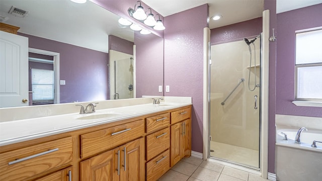 bathroom with tile patterned flooring, vanity, and shower with separate bathtub