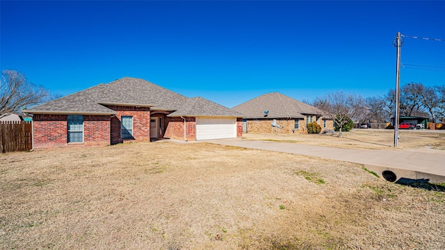 view of front facade with a garage and a front lawn