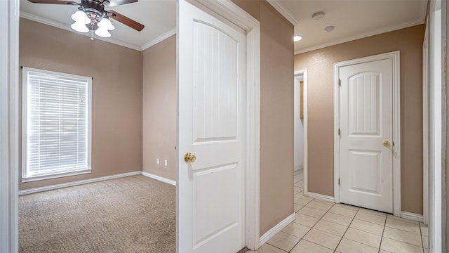 hall featuring ornamental molding and light tile patterned floors