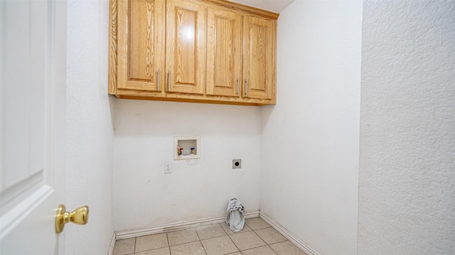 washroom with light tile patterned flooring, cabinets, washer hookup, and hookup for an electric dryer