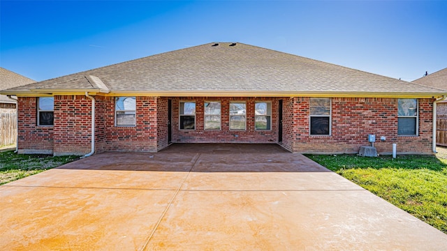 rear view of property featuring a yard