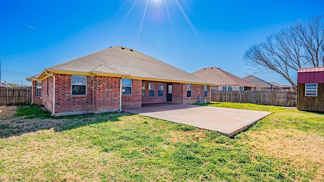 back of house featuring a patio area and a lawn