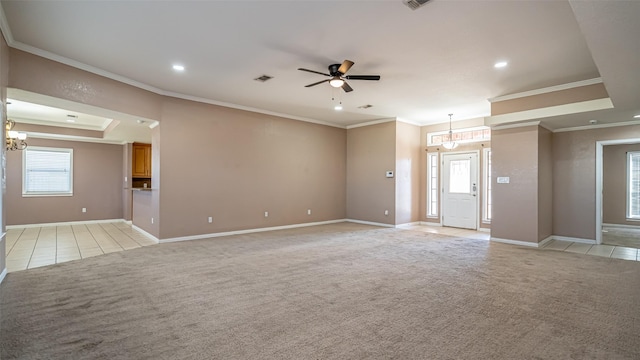 carpeted empty room featuring crown molding, a raised ceiling, and ceiling fan with notable chandelier