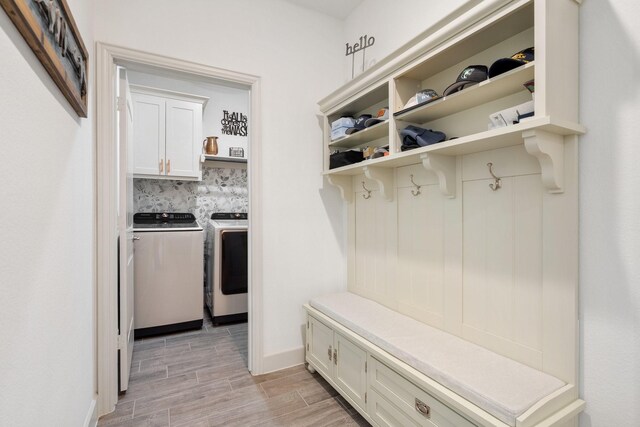 bathroom with wood-type flooring, a tile shower, vanity, and toilet