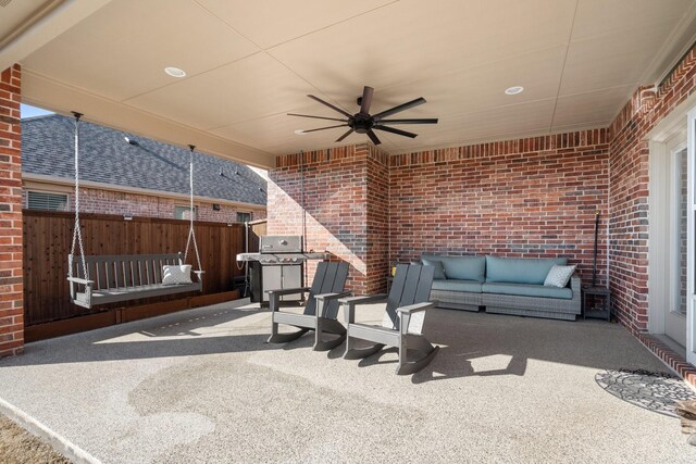 living room with ceiling fan, a stone fireplace, high vaulted ceiling, and light hardwood / wood-style floors