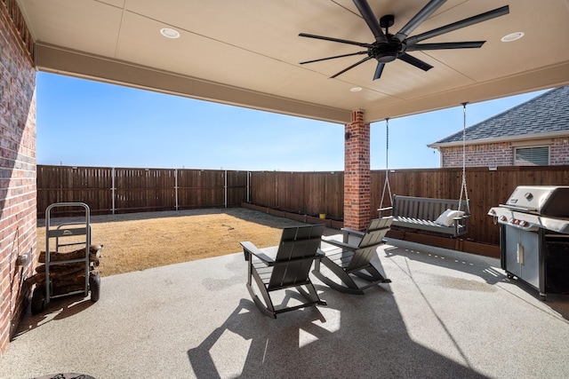 486 Colt Dr, Lavon, TX 75166 - fenced backyard with ceiling fan, a patio area, and grilling area