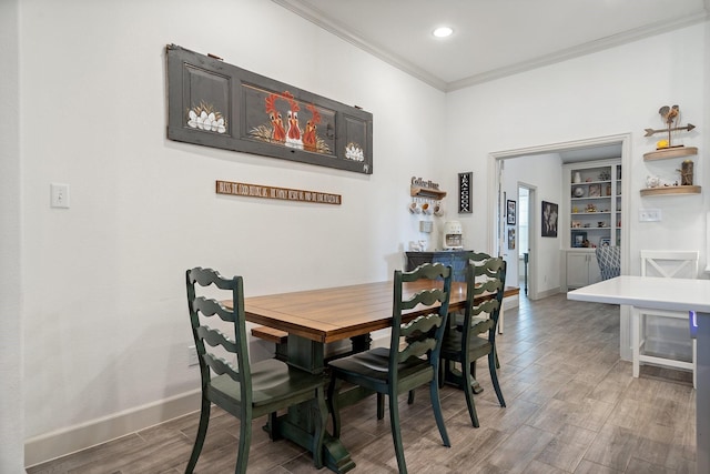 dining area featuring crown molding, recessed lighting, light wood-style floors, and baseboards