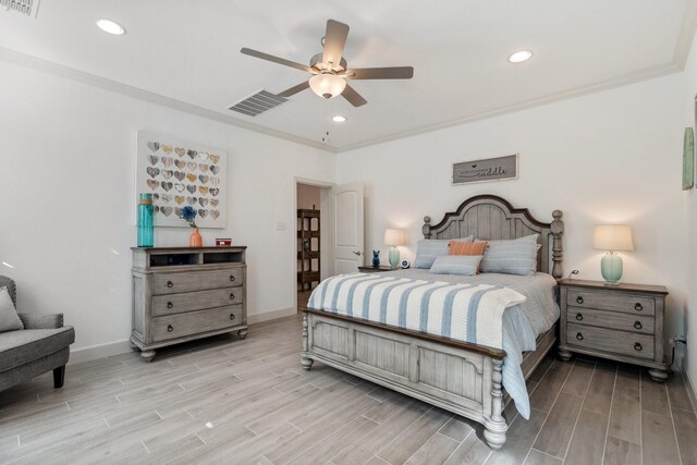 bedroom featuring crown molding, ceiling fan, and light hardwood / wood-style floors