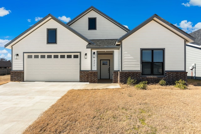 view of front of home with a garage and a front yard