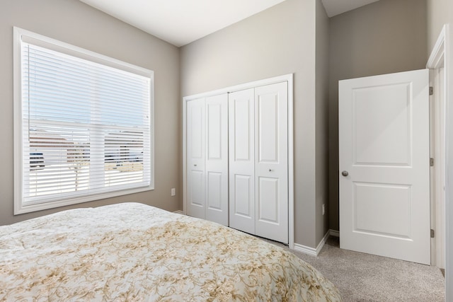 unfurnished bedroom featuring light carpet and a closet