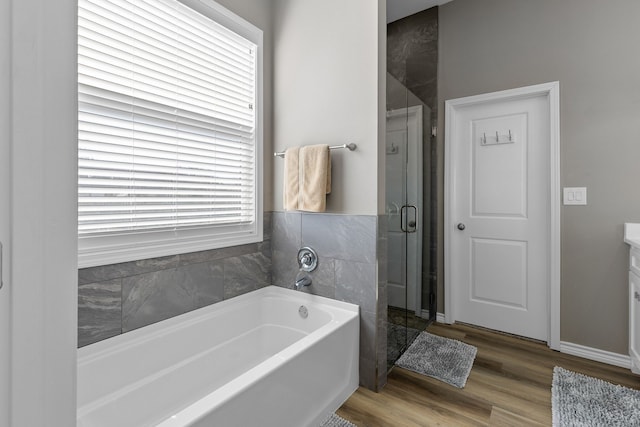 bathroom with vanity, shower with separate bathtub, and wood-type flooring