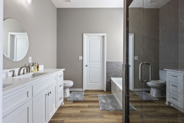 full bathroom with vanity, toilet, hardwood / wood-style floors, and tile walls