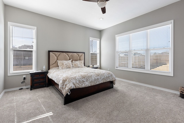 bedroom with multiple windows, carpet floors, and ceiling fan