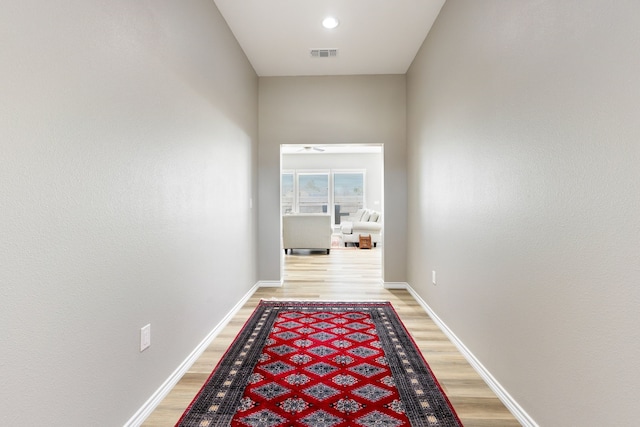 corridor with light hardwood / wood-style floors