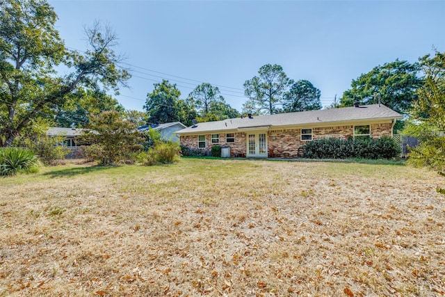 exterior space with french doors and a front lawn