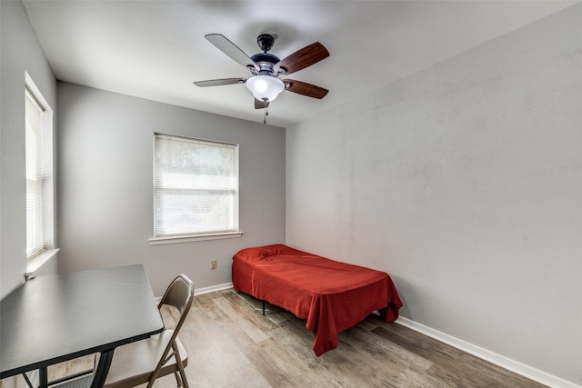 bedroom with ceiling fan and light hardwood / wood-style flooring