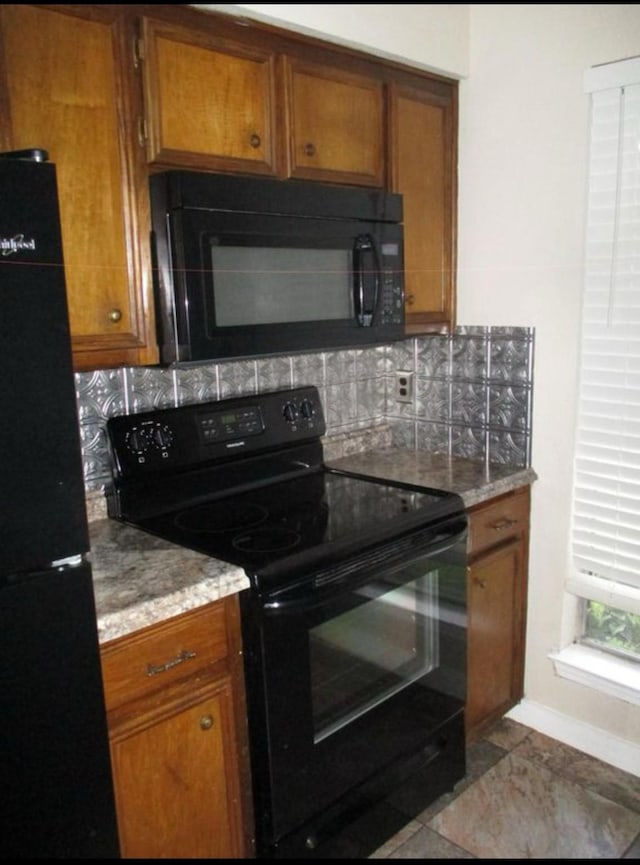 kitchen with decorative backsplash and black appliances