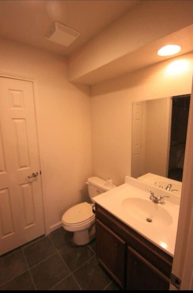 bathroom featuring tile patterned flooring, vanity, and toilet