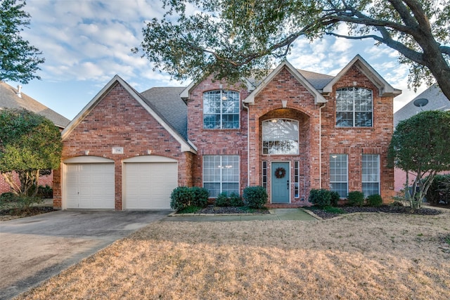 view of front property featuring a garage and a front yard