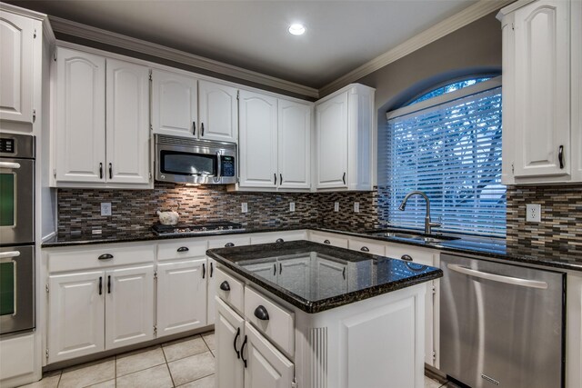 kitchen featuring appliances with stainless steel finishes, sink, and white cabinets