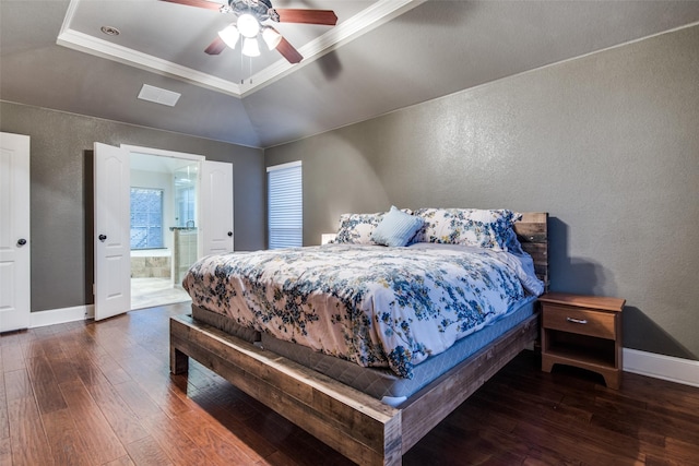 bedroom featuring a raised ceiling, dark hardwood / wood-style floors, connected bathroom, and ceiling fan