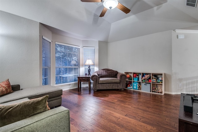 living room featuring vaulted ceiling, dark hardwood / wood-style floors, and ceiling fan