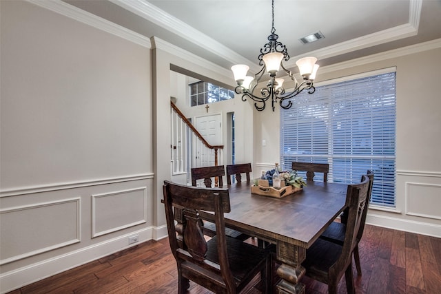 dining room featuring a raised ceiling, crown molding, a chandelier, and dark hardwood / wood-style flooring