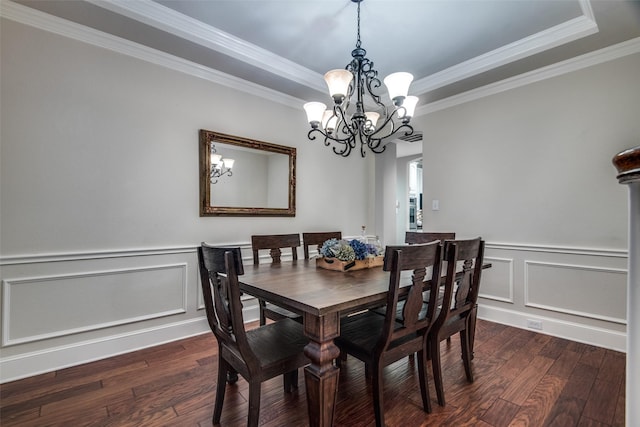 dining space featuring ornamental molding, dark hardwood / wood-style floors, and a raised ceiling