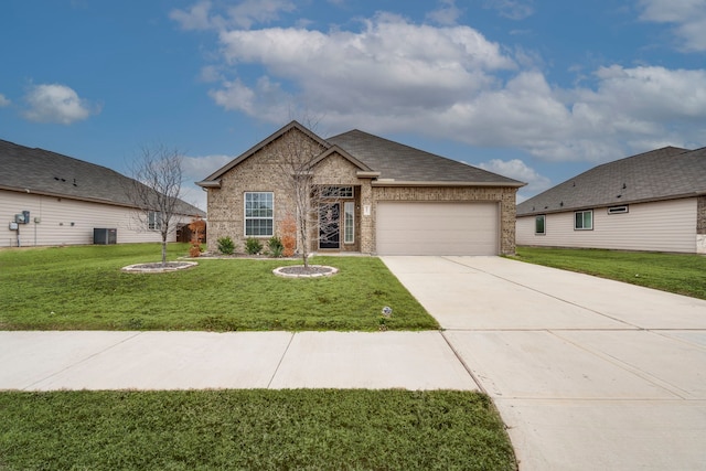 view of front of house with central AC unit, a garage, and a front lawn