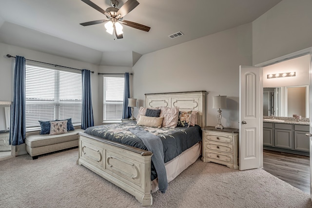 bedroom with lofted ceiling, sink, light colored carpet, and ceiling fan