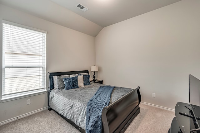 bedroom with lofted ceiling and light carpet