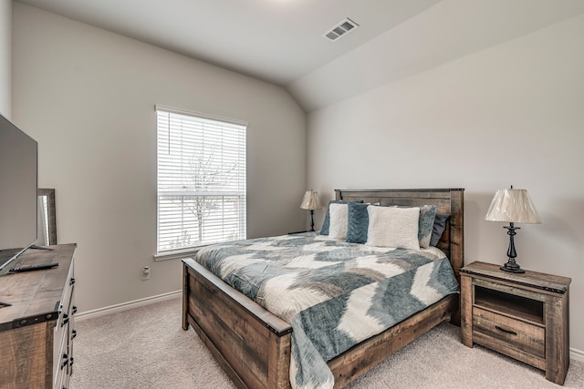 carpeted bedroom with lofted ceiling