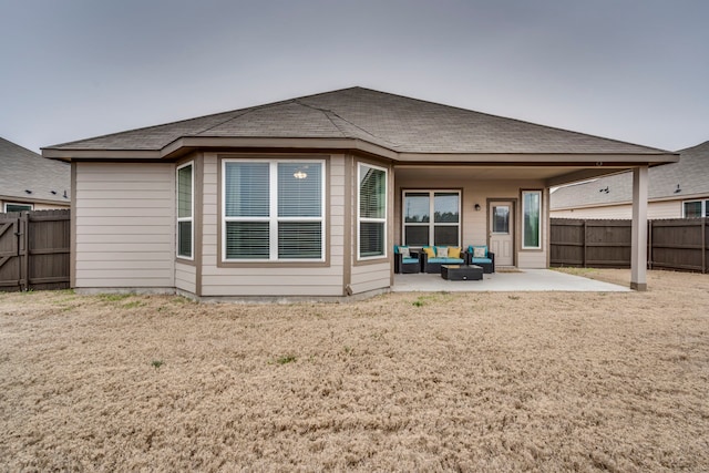 rear view of property with outdoor lounge area, a yard, and a patio area