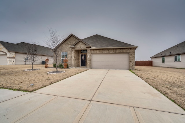 view of front of home with a garage and a front lawn