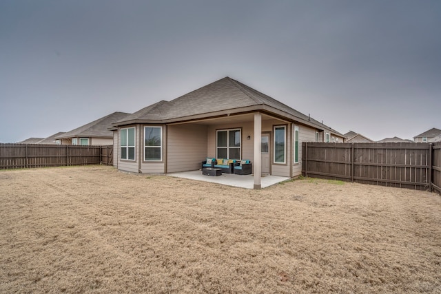 back of property featuring an outdoor living space, a yard, and a patio area