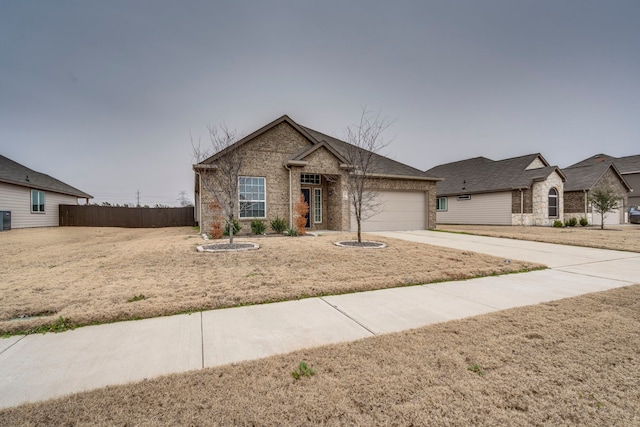 view of front facade with central AC, a garage, and a front yard