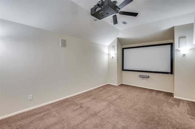 home theater room with vaulted ceiling, carpet, and ceiling fan