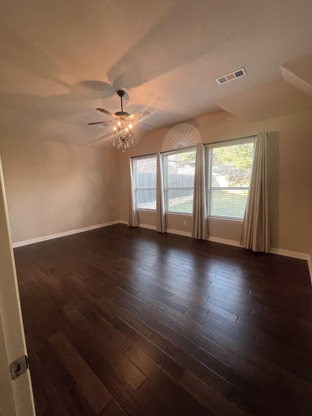 spare room featuring lofted ceiling, dark wood-type flooring, and ceiling fan